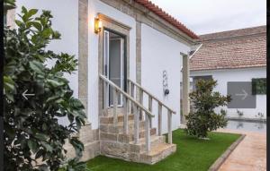 a villa with a staircase to a house at O Cantinho da Cotovia in Valpaços