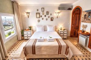 a bedroom with a large bed with two towels on it at Le balcon de tanger in Tangier