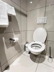 a bathroom with a toilet and a roll of toilet paper at Finagaello 3 bedrooms-Self catering at 77 on Independence in Windhoek +19 photos