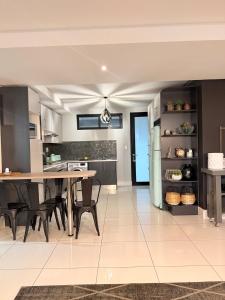 a kitchen and dining room with a table and chairs at Finagaello 3 bedrooms-Self catering at 77 on Independence in Windhoek