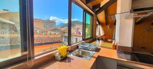 a kitchen with a sink and a large window at TAO casa WOOD apartamentos in Olot