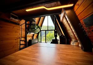 a hallway in a house with a large window at M Cabin A Frame Predeal 2 Ciubar in Predeal