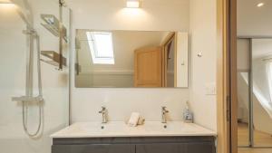 a bathroom with a sink and a mirror at Villa Coubertin in La Rivière-de-Corps +14 photos
