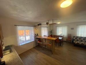 a living room with a table and a dining room at Chalupa Besednice in Besednice
