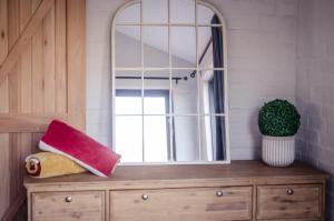a mirror on top of a dresser in a room at Genadendaal Vineyard Villa in Paarl +34 photos