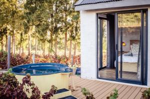 a house with a jacuzzi in a garden at Genadendaal Vineyard Villa in Paarl