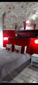 a bedroom with a large bed with a red headboard at RODRIGUEZ Luxury Suite in Ostuni