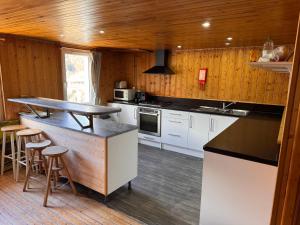 a kitchen with white cabinets and a wooden ceiling at Nash Apartment in Saint-Jean-d'Aulps