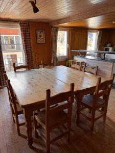 a large wooden table and chairs in a room at Nash Apartment in Saint-Jean-d'Aulps