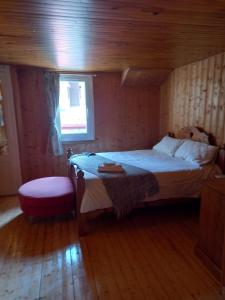 a small bedroom with a bed and a window at Nash Apartment in Saint-Jean-d'Aulps +4 photos