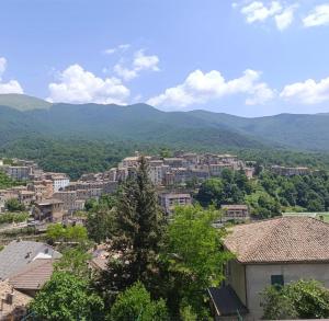 a view of a city with mountains in the background at Hotel Monte Viglio in Filettino