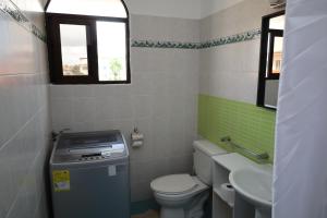 a small bathroom with a toilet and a sink at Venus Bayahibe by Mireya in Bayahibe