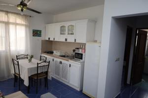 a kitchen with a table and a refrigerator and a table and chairs at Venus Bayahibe by Mireya in Bayahibe