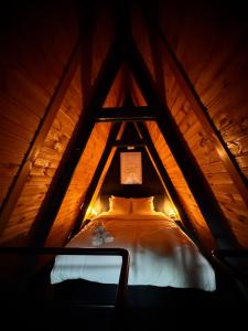 a bedroom in a tree house with a bed at M Cabin A Frame Predeal 2 Ciubar in Predeal