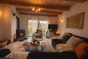 a living room with a couch and a fireplace at Forest Panorama Cabin Brezna in Plužine