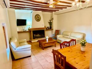a living room with a table and a fireplace at Rapia. Casa Rosa 2 in Moratalla