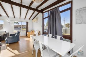 a dining room with a white table and chairs at Sea Gem in Lancelin