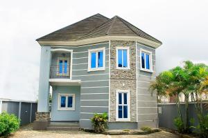 a small blue house with a roof at 21 Suites & Apartments in Mama