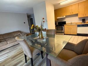 a living room with a glass table and a couch at Mountain House motor Inn Downtown Gatlinburg in Gatlinburg