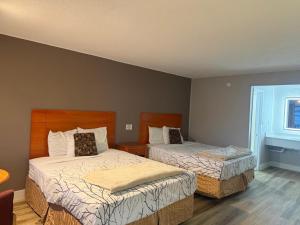 a bedroom with two beds and a window at Mountain House motor Inn Downtown Gatlinburg in Gatlinburg +12 photos