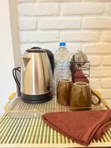 a toaster and two cups on a table at Teyra Lodge in Galle