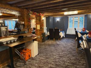 a room with a bar with a table and chairs at The Old Mill Inn in Bedford