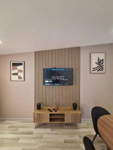 a living room with a flat screen tv on a wall at L'escale du Chemin des Dames in Cerny-en-Laonnois