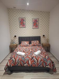 a bedroom with a large bed with pillows on it at L'escale du Chemin des Dames in Cerny-en-Laonnois