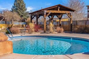 a swimming pool with a gazebo in a yard at Timber & Tin F 2Bed 2Bath w Pool & Rooftop Deck in Kanab