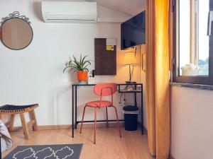 a room with a desk and a red chair at Lovely Room Silves in Silves