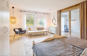 a bedroom with a bed and a living room at Ferienhaus Hängematte für Familien, Freunde und Gruppen in Barth