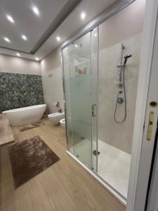 a bathroom with a glass shower and a tub at Martone house in Castellammare di Stabia +54 photos