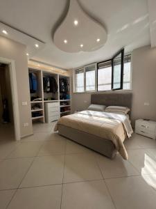 a bedroom with a large bed and a large tiled floor at Martone house in Castellammare di Stabia