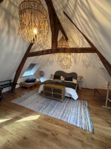 a bedroom with a bed and a chandelier in a tent at Maison Popeline in Les Andelys