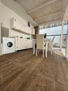 a kitchen with a table and a washing machine at Martone house in Castellammare di Stabia