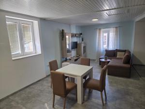 a living room with a table and chairs and a couch at Apartment Central in Šibenik