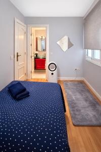 a bedroom with a blue bed and a carpet at Cosy and Secure Suite Marbella Center in Marbella