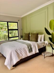 a bedroom with a large bed and a window at 101 Marais Villa in Hartbeespoort +47 photos