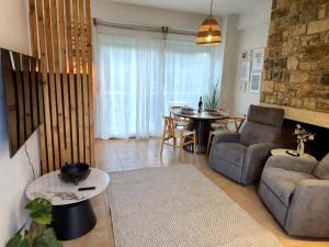 a living room with a couch and a table at Myrtos Olive Seaside Villa in Myrtos +37 photos