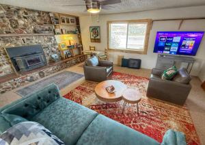 a living room with a couch and a television at Birds - King Suite Pets ok, Shared Kitchen #3 in Bluff