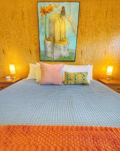 a bedroom with a bed with a painting on the wall at Birds - King Suite Pets ok, Shared Kitchen #3 in Bluff