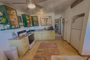 a kitchen with green cabinets and a white refrigerator at King Bear Mokee Pets OK, Shared Kitchen! #4 in Bluff