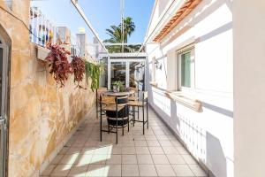 a balcony with a table and chairs on a building at The Denia Hideaway in Denia