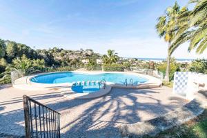 a swimming pool with a view of the ocean at The Denia Hideaway in Denia