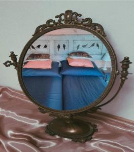 a mirror sitting on top of a bed at Siedlisko Ptasie Trele 2 in Jerutki