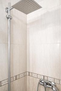 a shower with a shower head in a bathroom at Cosy and Secure Suite Marbella Center in Marbella