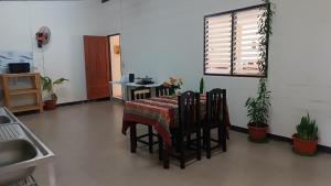 a kitchen with a table with chairs and a window at Pai Town Home in Pai +52 photos
