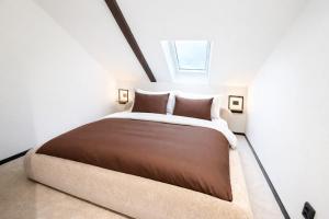 a bedroom with a large bed with a window at Studio 28 in Narvik