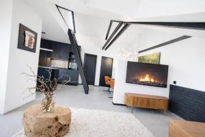 a living room with a fireplace and a tv at Studio 28 in Narvik