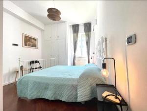 a bedroom with a bed with a blue blanket at Anzio lighthouse terrace family-group friendly in Anzio